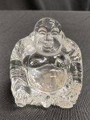 A GLASS FIGURE OF A SEATED BUDDHA