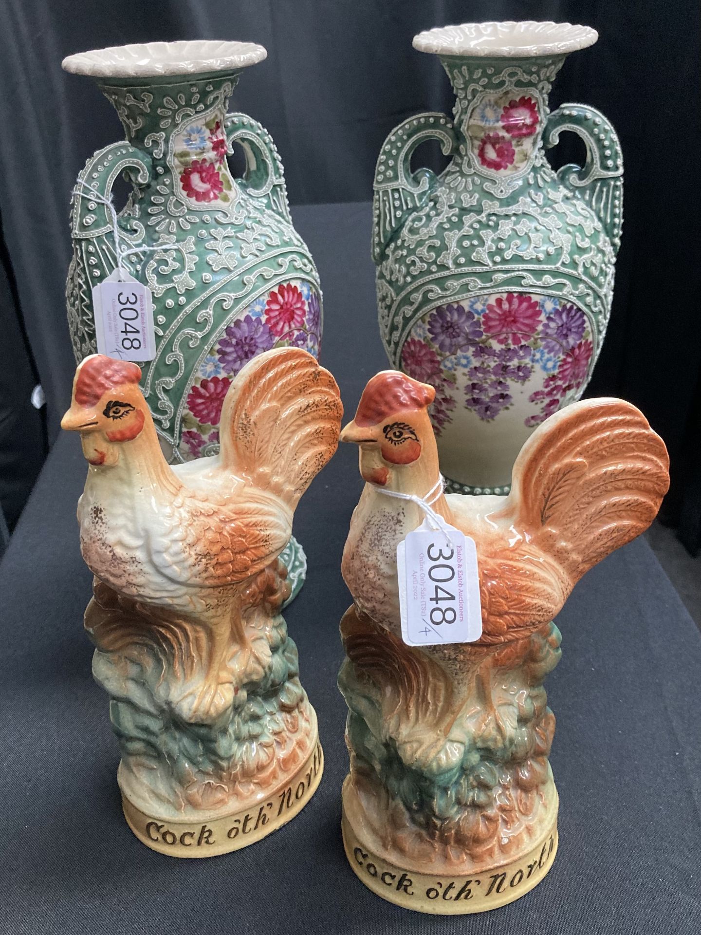 Two Staffordshire ‘Cock o’th’ North’ models, and two baluster vases