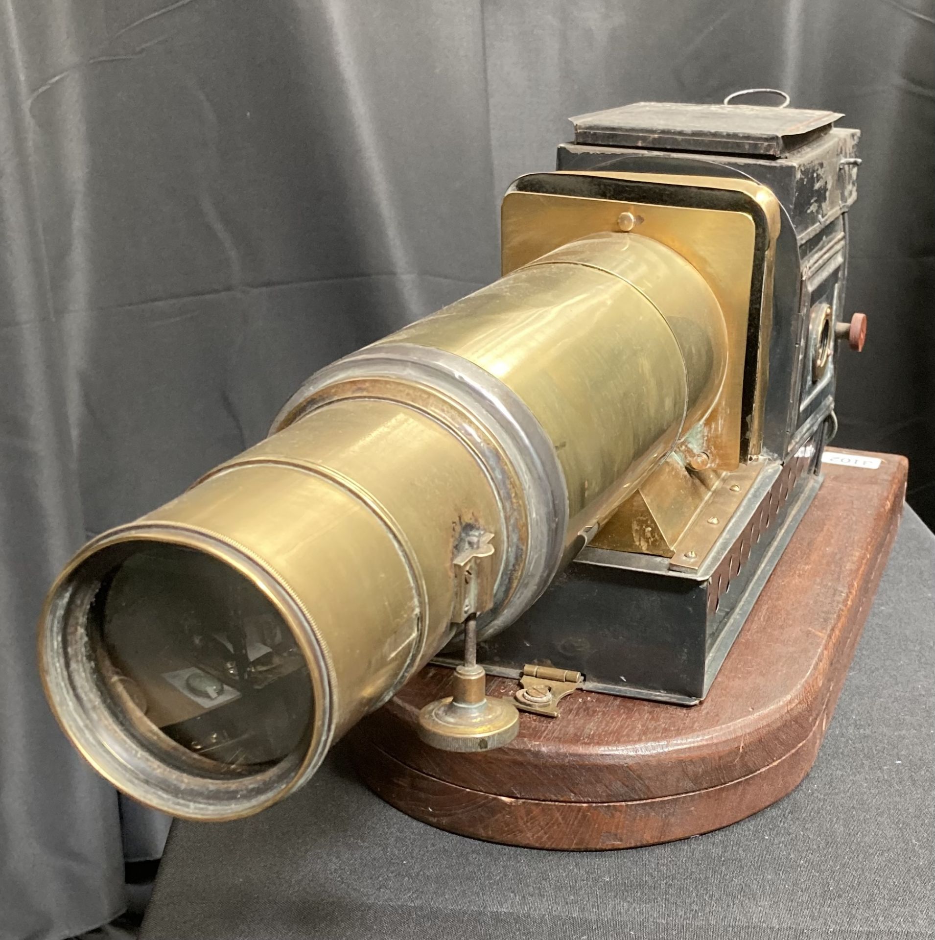 A 19TH CENTURY TIN AND BRASS MAGIC LANTERN AND SLIDES