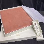 A ROLEX LEATHER NOTEPAD AND TIE-PIN
