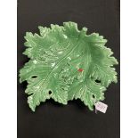 A Continental green glazed pottery leaf dish