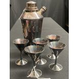 A silver-plated cocktail shaker and five glasses