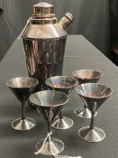A silver-plated cocktail shaker and five glasses