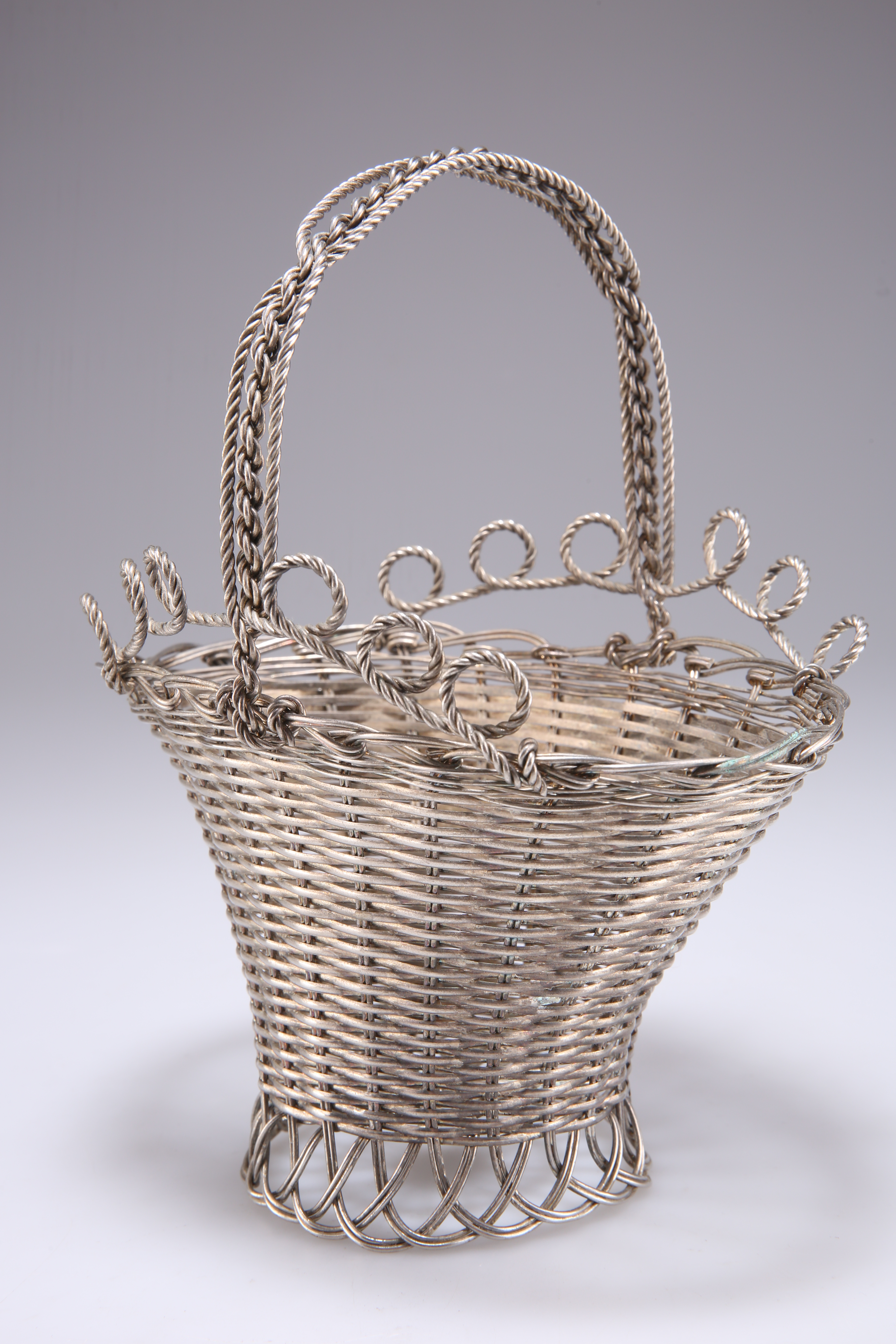 A CONTINENTAL WHITE-METAL WIREWORK BASKET