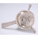 AN ARTS AND CRAFTS SILVER TEA STRAINER