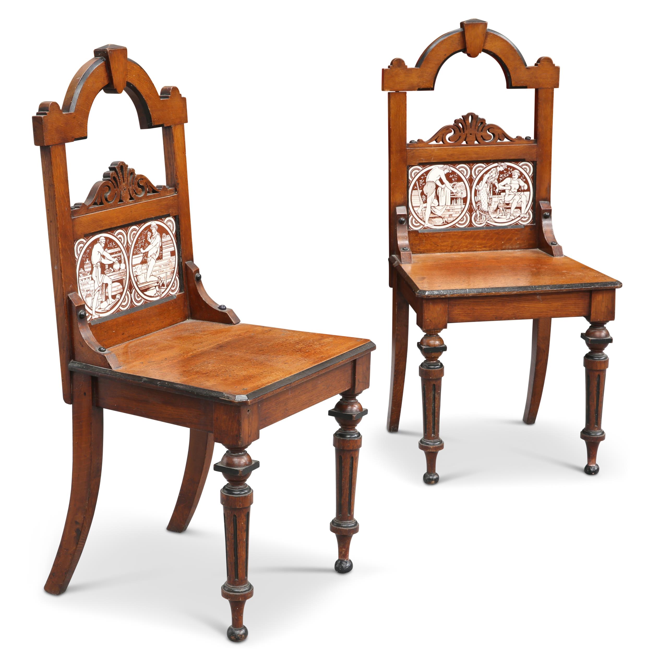 A PAIR OF VICTORIAN OAK HALL CHAIRS WITH MINTON TILES