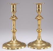 A PAIR OF 18TH CENTURY BRASS PETAL-BASE CANDLESTICKS