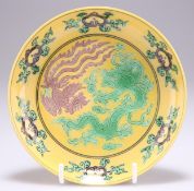 A CHINESE YELLOW-GROUND GREEN AND AUBERGINE 'DRAGON' DISH