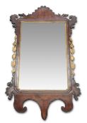 A GEORGE III PARCEL-GILT MAHOGANY FRETWORK MIRROR