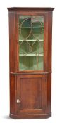 A GEORGE III MAHOGANY FLOOR-STANDING CORNER CABINET