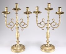 A LARGE PAIR OF VICTORIAN HEAVY BRASS THREE-LIGHT CANDELABRA