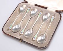 A SET OF SIX ART DECO SILVER AND ENAMEL COFFEE SPOONS