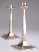 A PAIR OF ARTS AND CRAFTS SILVER CANDLESTICKS