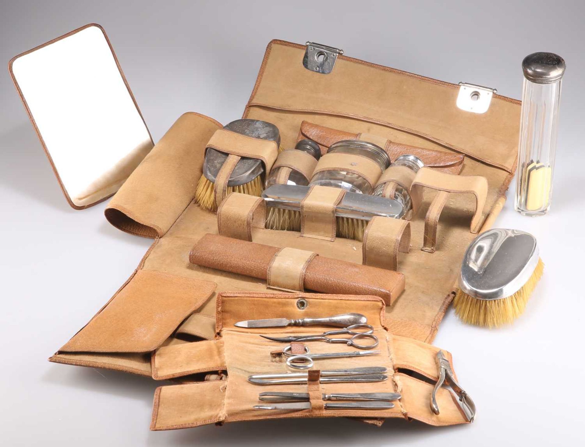 AN EDWARDIAN GENTLEMAN'S SILVER-TOPPED DRESSING TABLE SET AND MANICURE SET