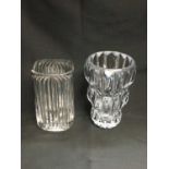 A ROGASKA CRYSTAL CLEAR GLASS VASE, 25cm high; and A FLUTED CLEAR GLASS VASE, 22.5cm high. (2)