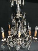 A LARGE METAL AND LUSTRE DROP CHANDELIER
