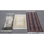 A SMALL CHINESE RUG TOGETHER WITH TWO PAKISTANI RUGS