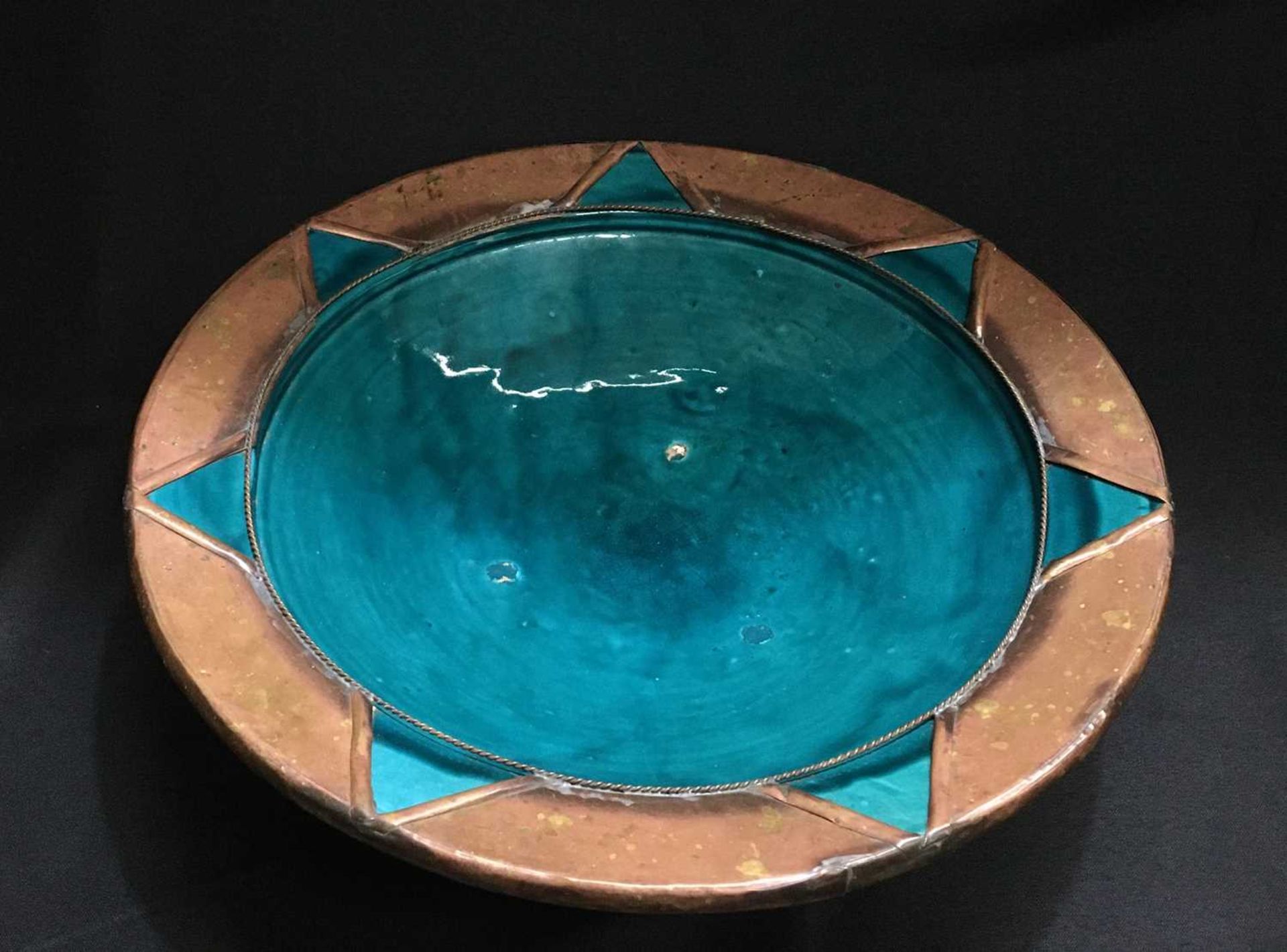 AN ISLAMIC COPPER-MOUNTED POTTERY BOWL