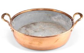 A COPPER TWO-HANDLED CREAM PAN