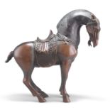 A CHINESE PATINATED BRONZE MODEL OF A TANG STYLE HORSE