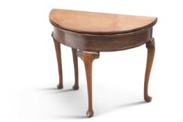 A GEORGE II STYLE MAHOGANY DEMILUNE FOLDOVER TEA TABLE