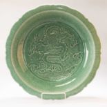 A LARGE CHINESE CELADON DRAGON DISH