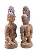 A PAIR OF NIGERIAN YORUBA 'ERE IBEJI' TWIN MALE CARVED WOODEN FIGURES, EARLY 20TH CENTURY