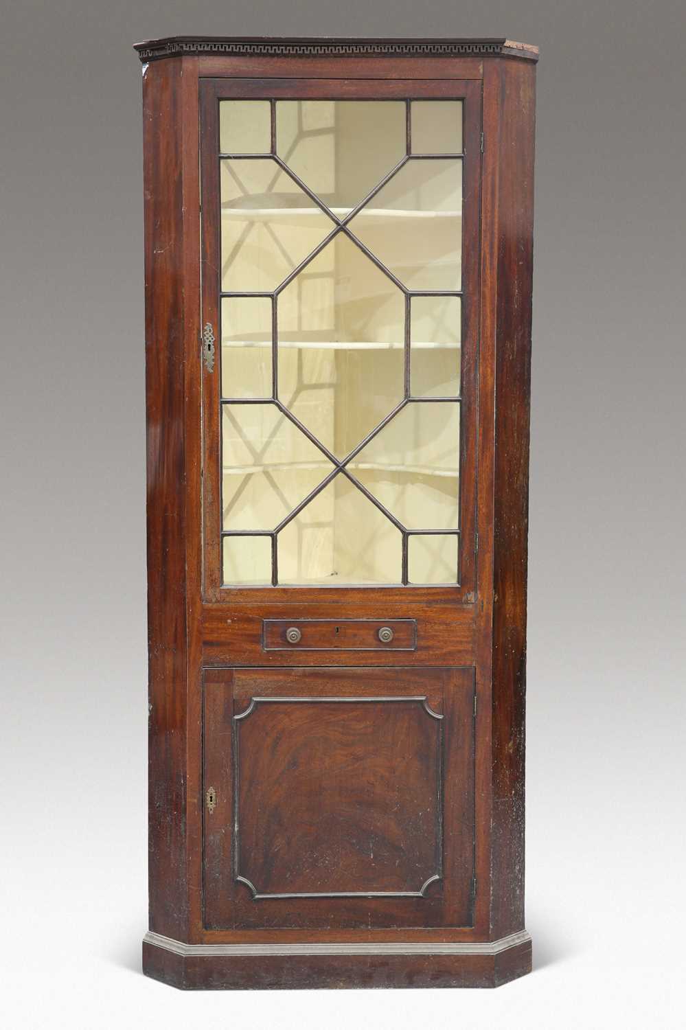 A GEORGE III MAHOGANY FLOOR-STANDING CORNER CABINET