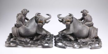 A PAIR OF EARLY 20TH CENTURY CHINESE HARDWOOD BOY AND BUFFALO GROUPS