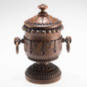 A 19TH CENTURY CARVED OAK TOBACCO JAR AND COVER