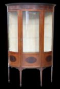 AN EDWARDIAN INLAID MAHOGANY DEMILUNE VITRINE