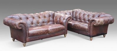 A PAIR OF DEEP-BUTTONED BROWN LEATHER CHESTERFIELD SETTEES
