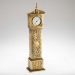 A MINIATURE BRASS LONGCASE CLOCK