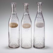 A SET OF THREE BACCARAT CUT-GLASS DECANTERS