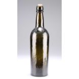 A PLANISHED GREEN GLASS WINE BOTTLE, 18TH/19TH CENTURY