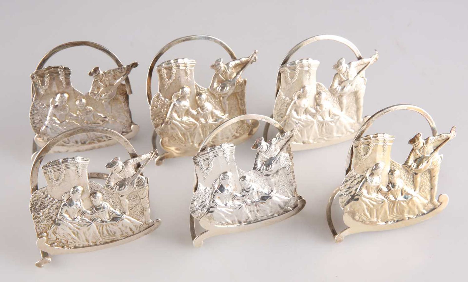 A SET OF SIX EDWARDIAN SILVER MENU HOLDERS