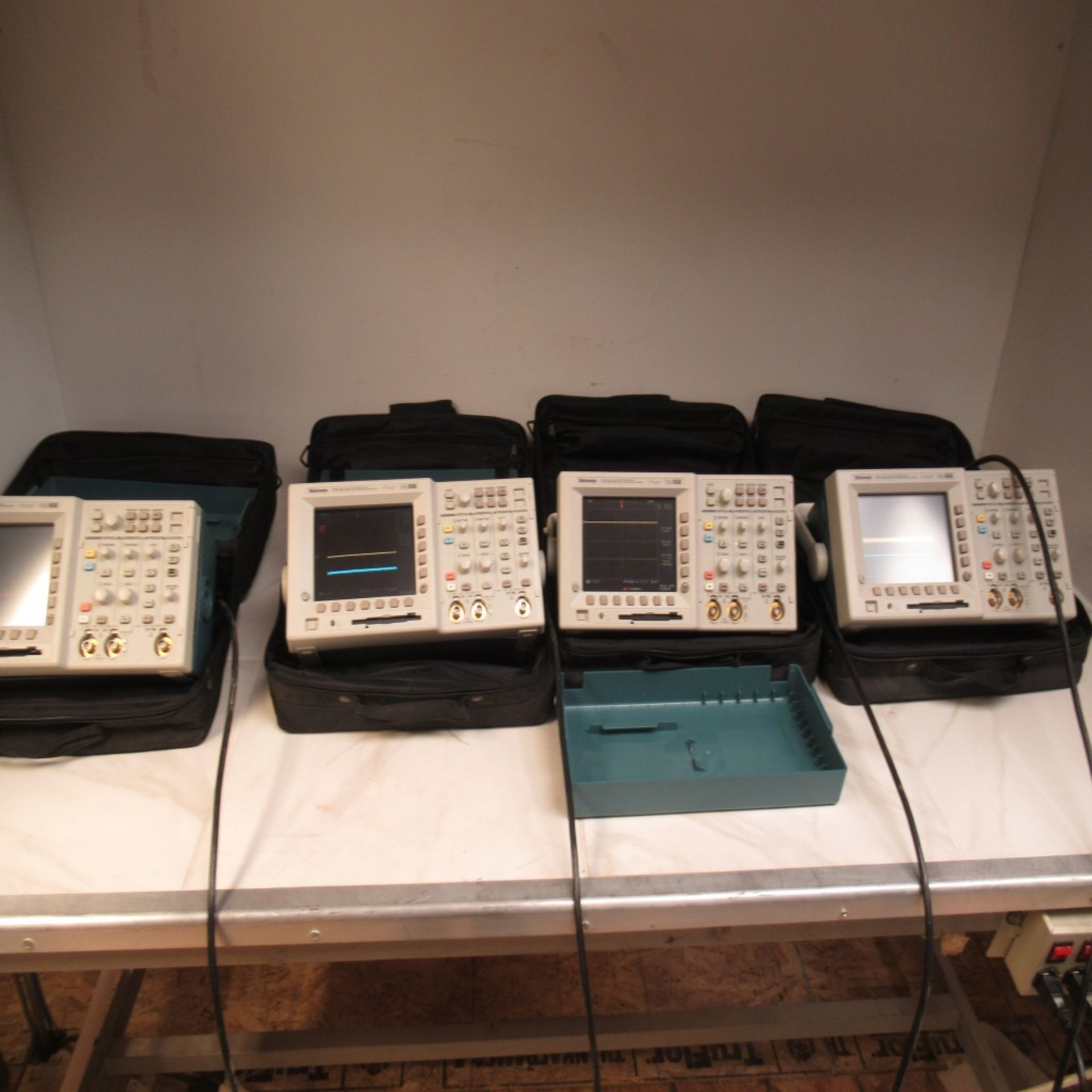 LOT OF 4 TEKTRONIX TDS3012B TWO CHANNEL DIGITAL PHOSPHOR OSCILLOSCOPES, WITH PADDED CARRY CASES AND