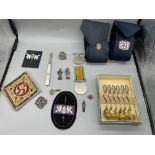 Assorted lot to include 830S Silver Spoons, Badges