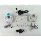 Sega Dreamcast console - released in 1998 - console and 2 controllers, one with a Joytech 1MB memory