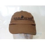 WAR HORSE (2011) - A group of three crew clothing items comprising a brown cap ; a black short