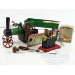 A MAMOD live steam traction engine together with 4 wheel trailer, a stationery steam engine and a