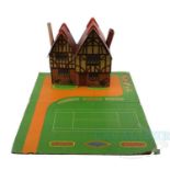 A DINKY pre-war 'Dolly Varden' Dolls House comprising a half-timbered dwelling made in printed