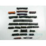 A group of N gauge mostly German outline rolling stock including an electric loco, wagons and