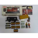 A small group of mostly O gauge model railways comprising an ATLAS diesel shunter, a wagon and