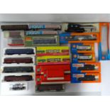 A group of boxed and unboxed European outline HO gauge wagons and coaches by ROCO, JOUEF and