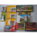 A group of HO gauge unbuilt buildings and accessories kits by POLA, FALLER and others, some still