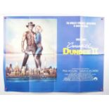 A group of movie posters comprising CROCODILE DUNDEE (1986); CROCODILE DUNDEE II (1988); TARZAN