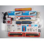 A mixed group of OO gauge rolling stock and accessories mostly by HORNBY and PECO to include an