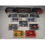 A group of HOTWHEELS and MINICHAMPS 1:43 scale Formula 1 diecast racing cars, including three signed