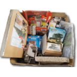 A large removals box of OO / HO gauge model railway kits and scenic accessories, not all complete,
